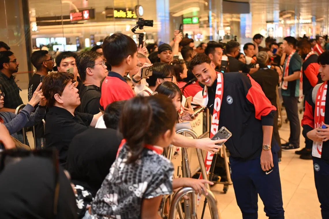 Ilhan Fandi interacting with fans at Changi Airport on Nov 19 after returning with the Singapore team from Hong Kong.
