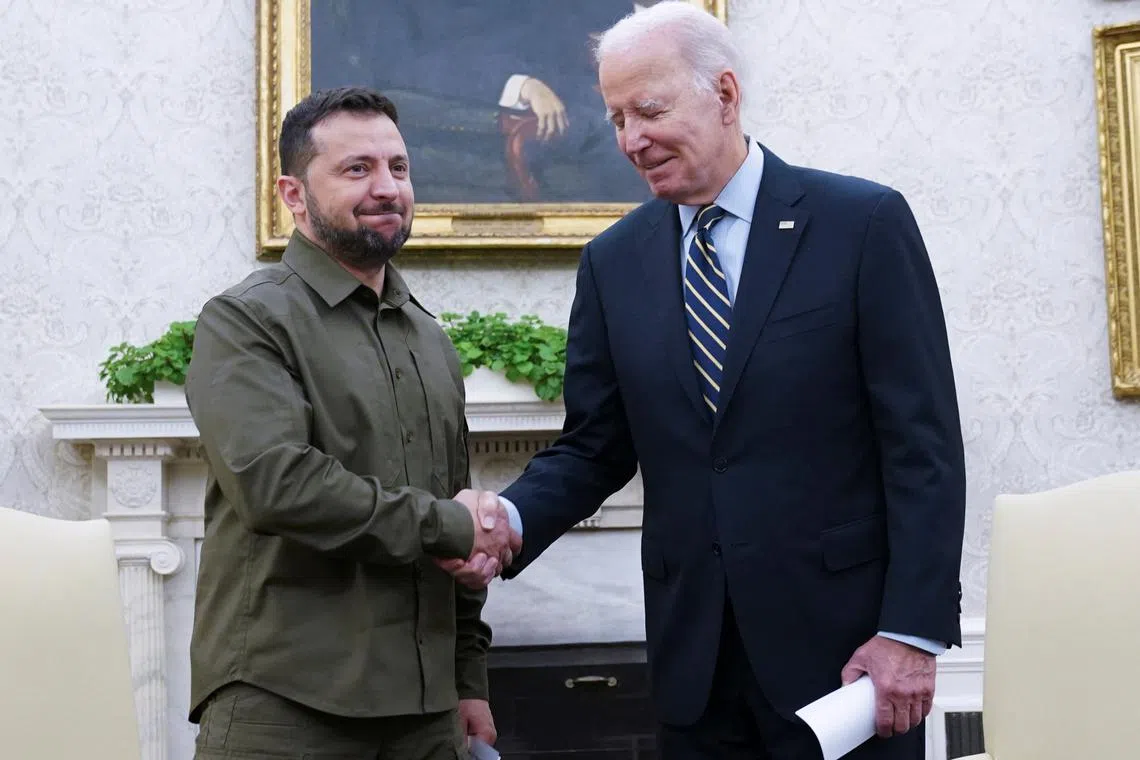 FILE PHOTO: U.S. President Joe Biden shakes hands with Ukrainian President Volodymyr Zelenskiy as they meet in the Oval Office of the White House in Washington, September 21, 2023. REUTERS/Kevin Lamarque/File Photo