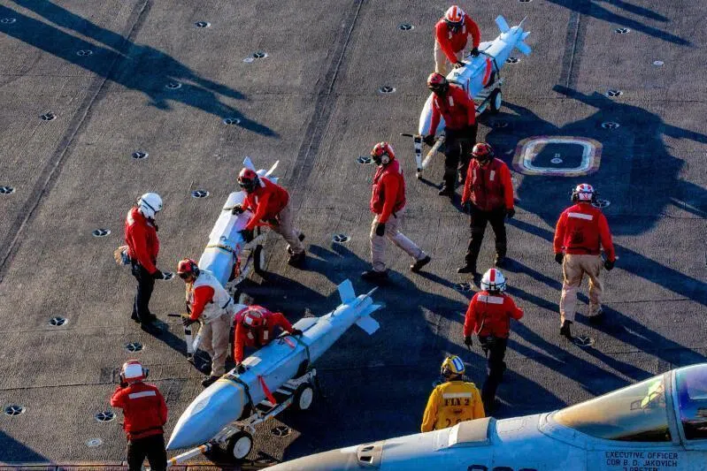 US sailors moving ordnance on the flight deck of Nimitz-class aircraft carrier USS Abraham Lincoln in support of the operation against Iran on Feb 28, 2026. 