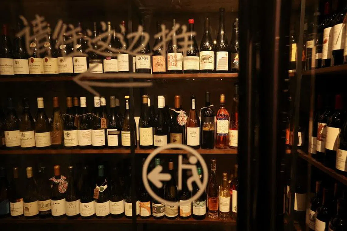 Wine bottles from around the world fill shelves in the cellar of Trio Wine Bar in Beijing, China November 1, 2023. REUTERS/Florence Lo