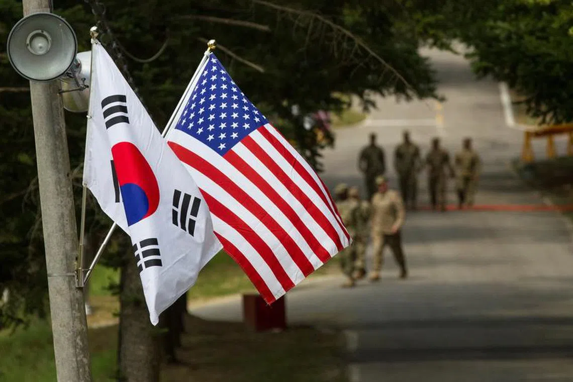 FILE PHOTO: The South Korean and American flags fly next to each other at Yongin, South Korea, August 23, 2016. Picture taken on August 23, 2016.  Courtesy Ken Scar/U.S. Army/Handout via REUTERS/File Photo