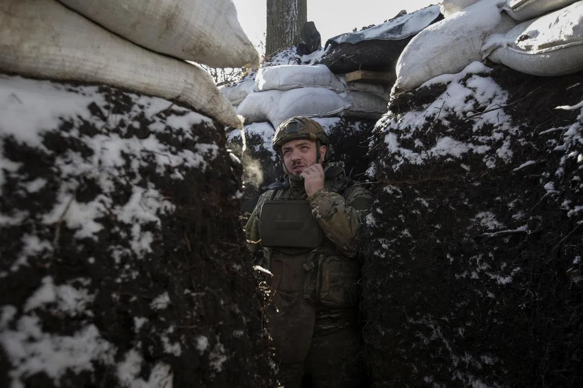 A Ukrainian serviceman is seen in a trench at a frontline, amid Russia's attack on Ukraine, in the Donetsk region in Ukraine on Jan 7, 2023.  