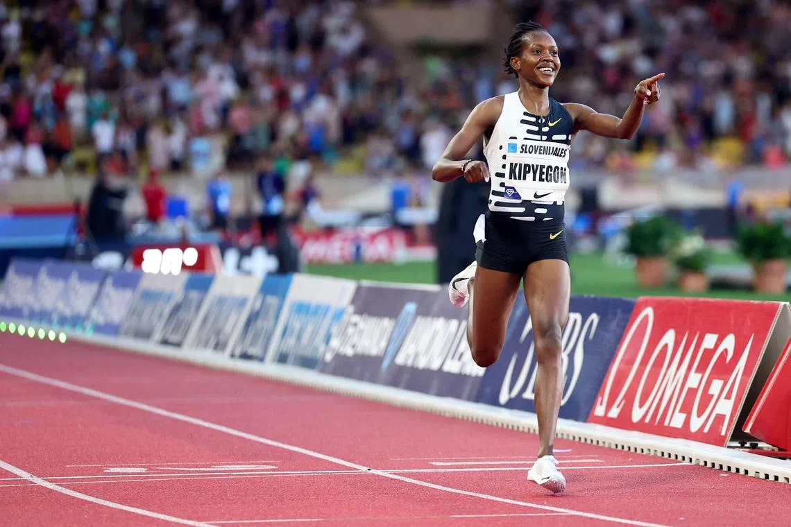 Faith Kipyegon of Kenya celebrates after breaking the world record in the women's One Mile event during the IAAF Diamond League "Herculis" meeting at the Louis II Stadium in Monaco.
