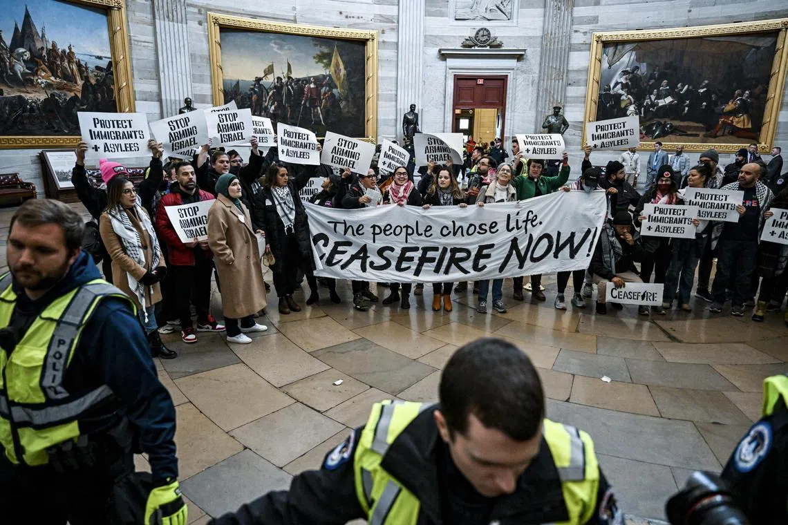 Activists opposing US military aid to Israel hold a protest at the Capitol Rotunda in Washington.