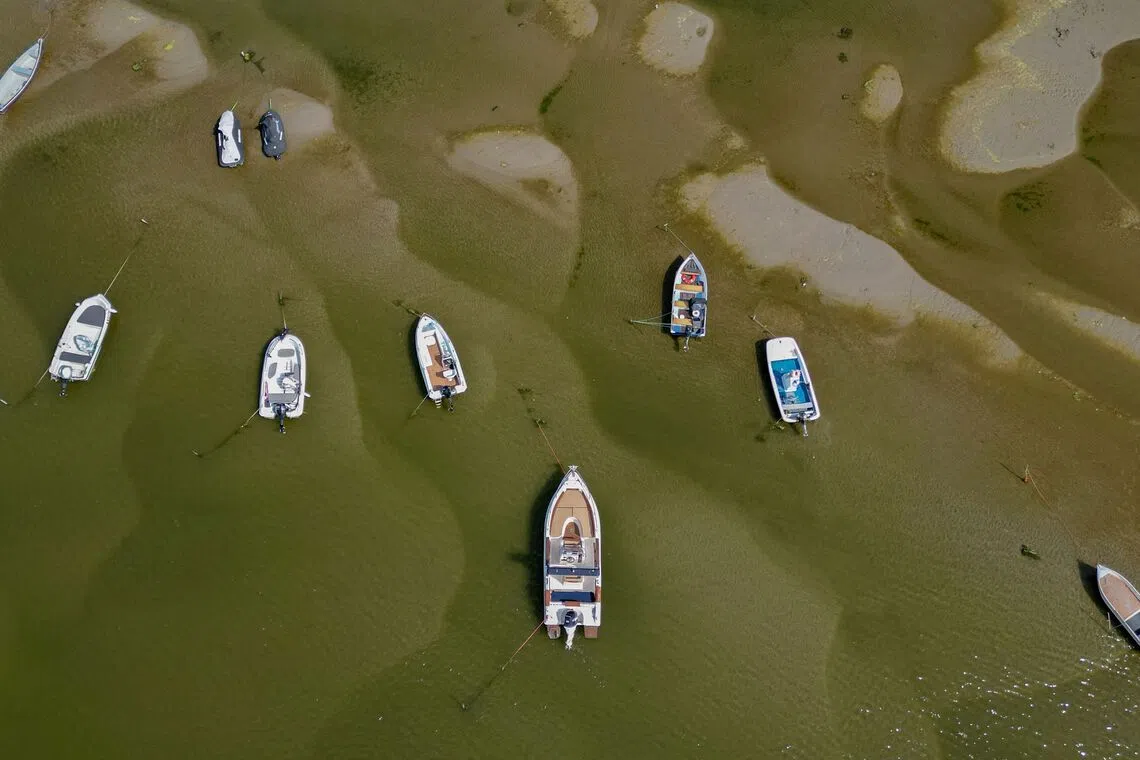 An aerial view of boats in the shallow water of the Danube river in Corabia, southern Romania, on July 24. Nuclear plants along the Danube river in Hungary and Romania could be completely shut down in the coming days owing to record low water levels.