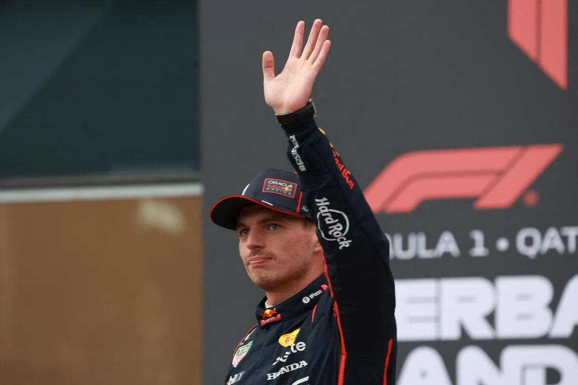 Red Bull's Max Verstappen celebrates after qualifying in pole position.