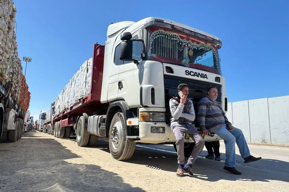 Trucks carrying humanitarian aid line up on the Egyptian side of the Rafah border crossing with the Gaza Strip on March 2, after Israel suspended the entry of supplies into the Palestinian enclave.