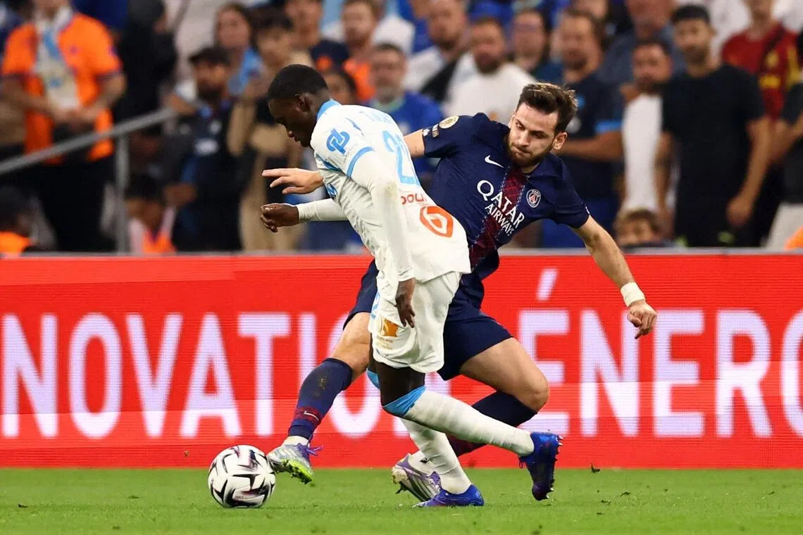 Marseille's Timothy Weah tussling for the ball with Paris St-Germain's Khvicha Kvaratskhelia in their French Ligue 1 match at Orange Velodrome in Marseille on Sept 22, 2025. 