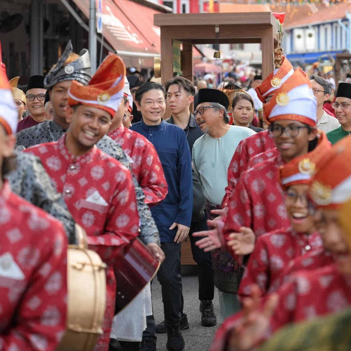 PM Lawrence Wong (centre, left), and Kampong Gelam Alliance chairman Zaki Ma’arof (centre, right) joining performers outside the Malay Heritage Centre during its reopening on April 25.