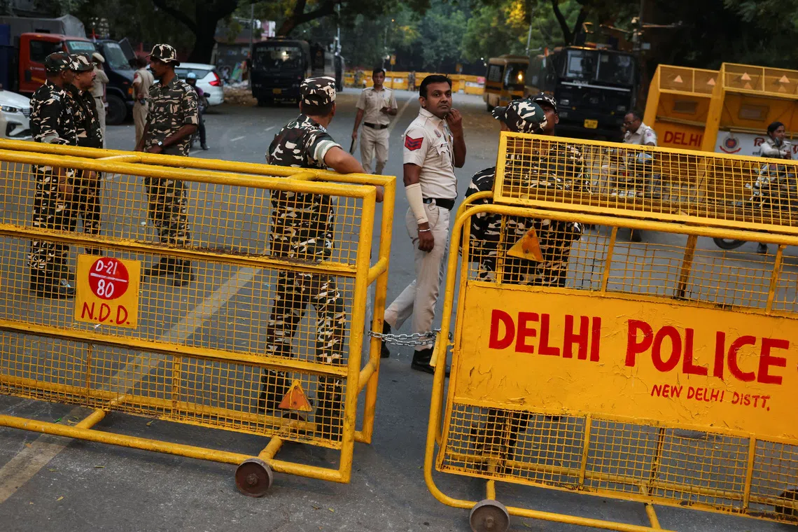 Security personnel stand next to barricades ahead of a protest planned by the Cockroach Janta Party near Jantar Mantar in New Delhi on Oct 9.
