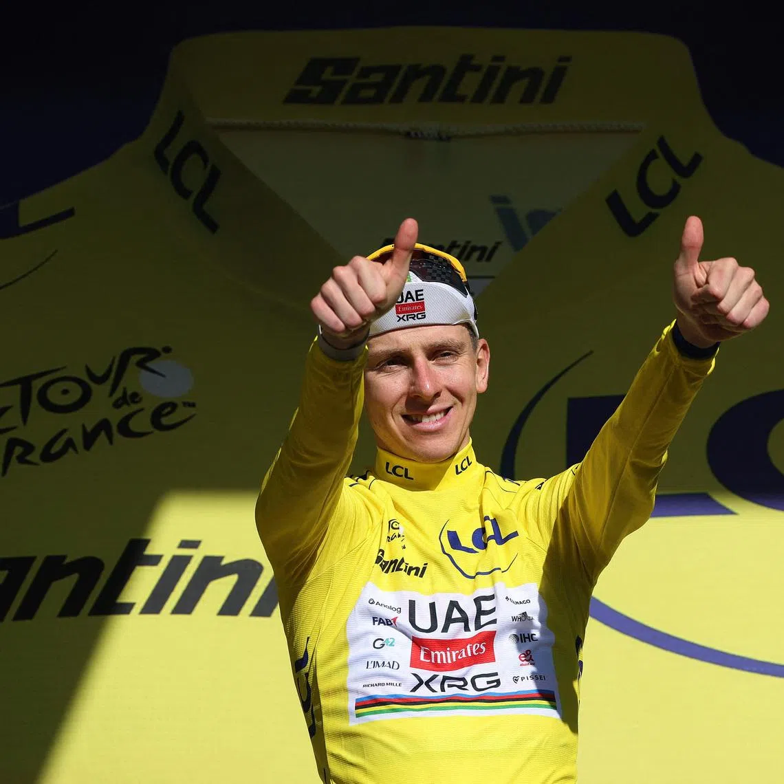 Cycling - Tour de France - Stage 10 - Aurillac to Le Lioran - Le Lioran, France - July 14, 2026 UAE Team Emirates - XRG's Tadej Pogacar celebrates on the podium wearing the yellow jersey after winning stage 10 REUTERS/Gonzalo Fuentes