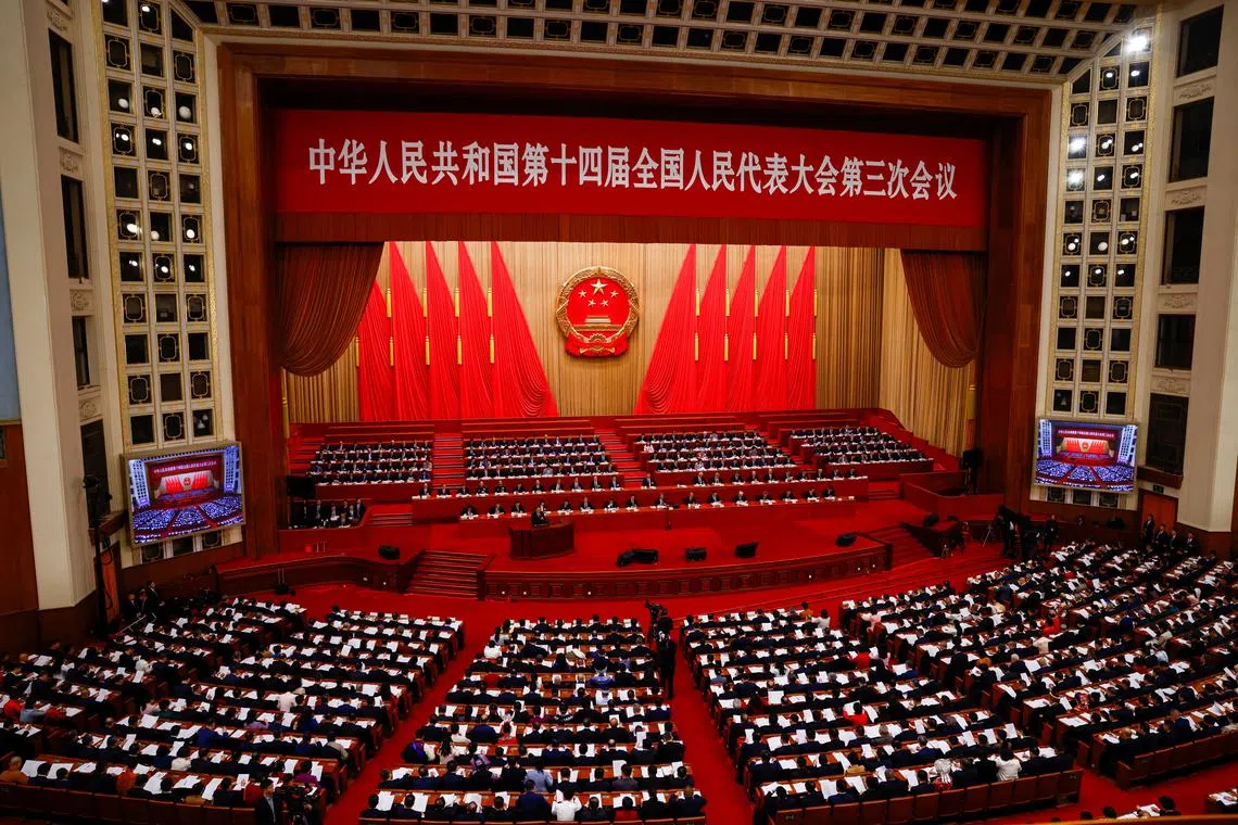 Chinese Premier Li Qiang delivers a speech during the opening session of the National People's Congress (NPC), at the Great Hall of the People, in Beijing, China March 5, 2025. REUTERS/Tingshu Wang