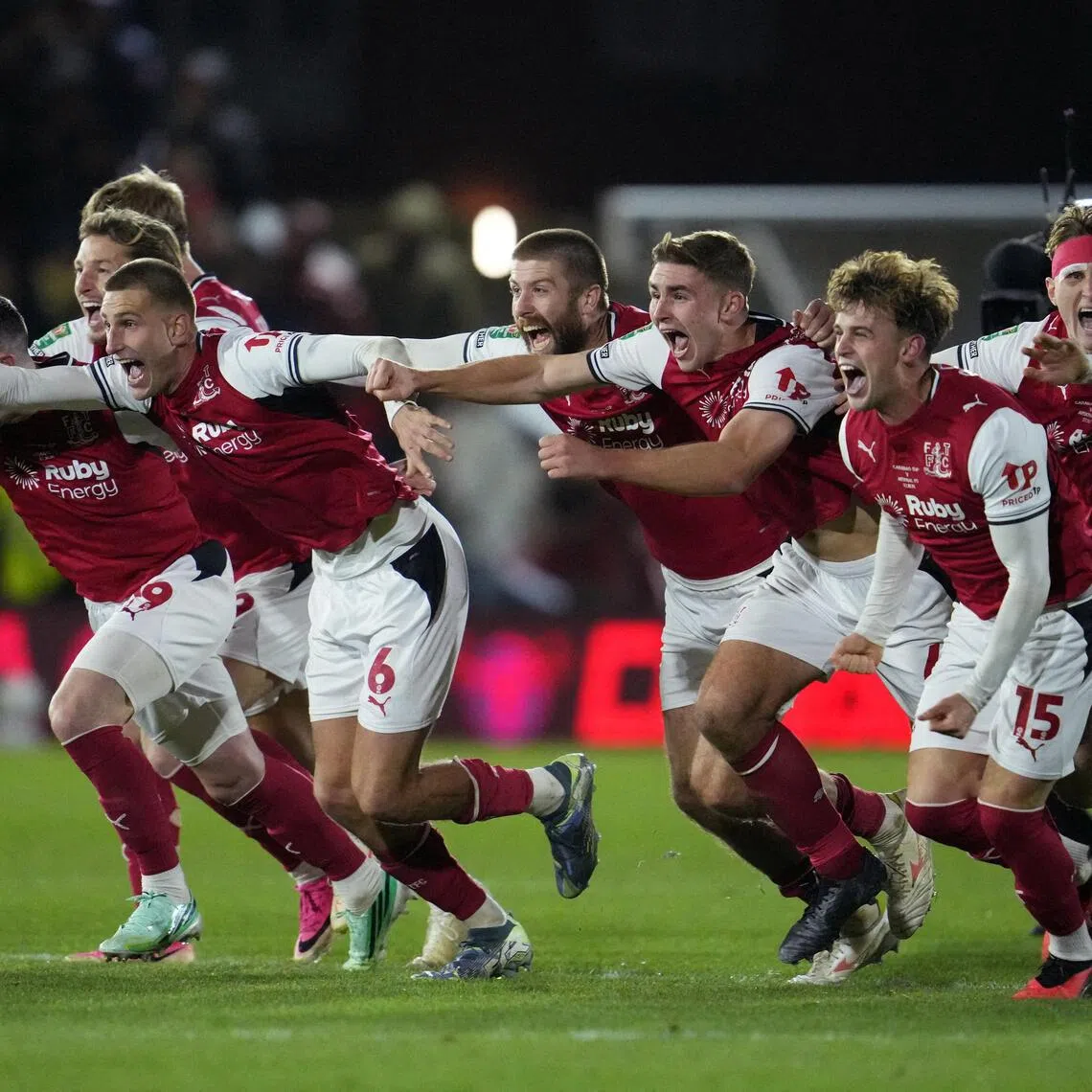 Fleetwood Town’s Rhys Bennett and his teammates celebrate winning the penalty shootout against Arsenal on Oct 27.