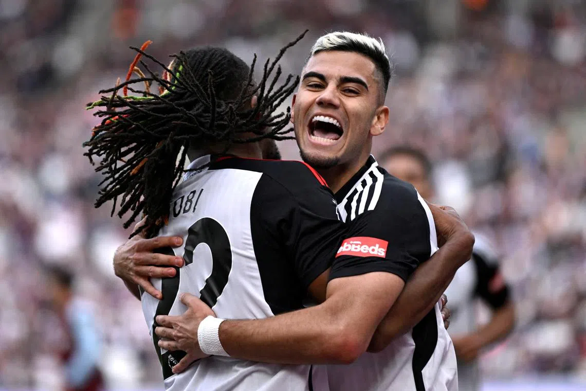 Soccer Football - Premier League - West Ham United v Fulham - London Stadium, London, Britain - April 14, 2024 Fulham's Andreas Pereira celebrates scoring their second goal with Alex Iwobi REUTERS/Tony Obrien