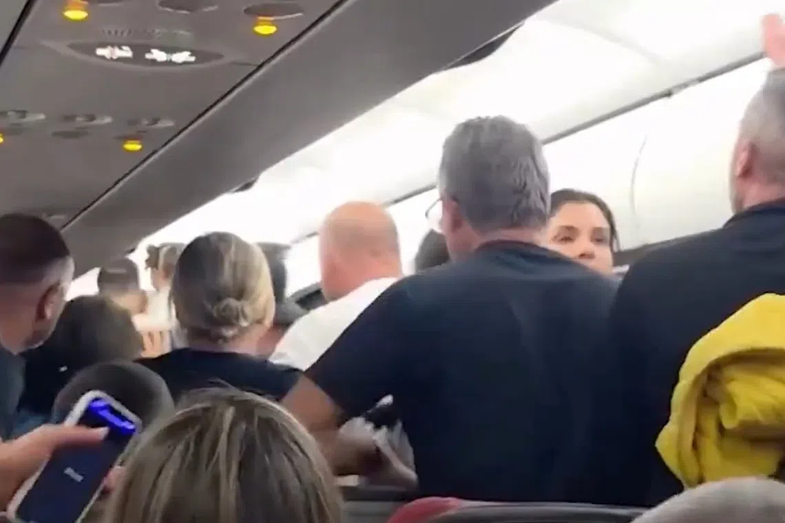 Passengers are told to leave the Latam Airlines plane, after a fire struck external equipment on the tarmac before departure.
