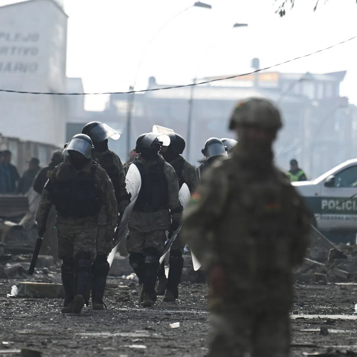 Military personnel walk through the affected area, a day after loud explosions that left people dead and injured at a military barracks, in Viacha, Bolivia, September 5, 2026. REUTERS/Claudia Morales