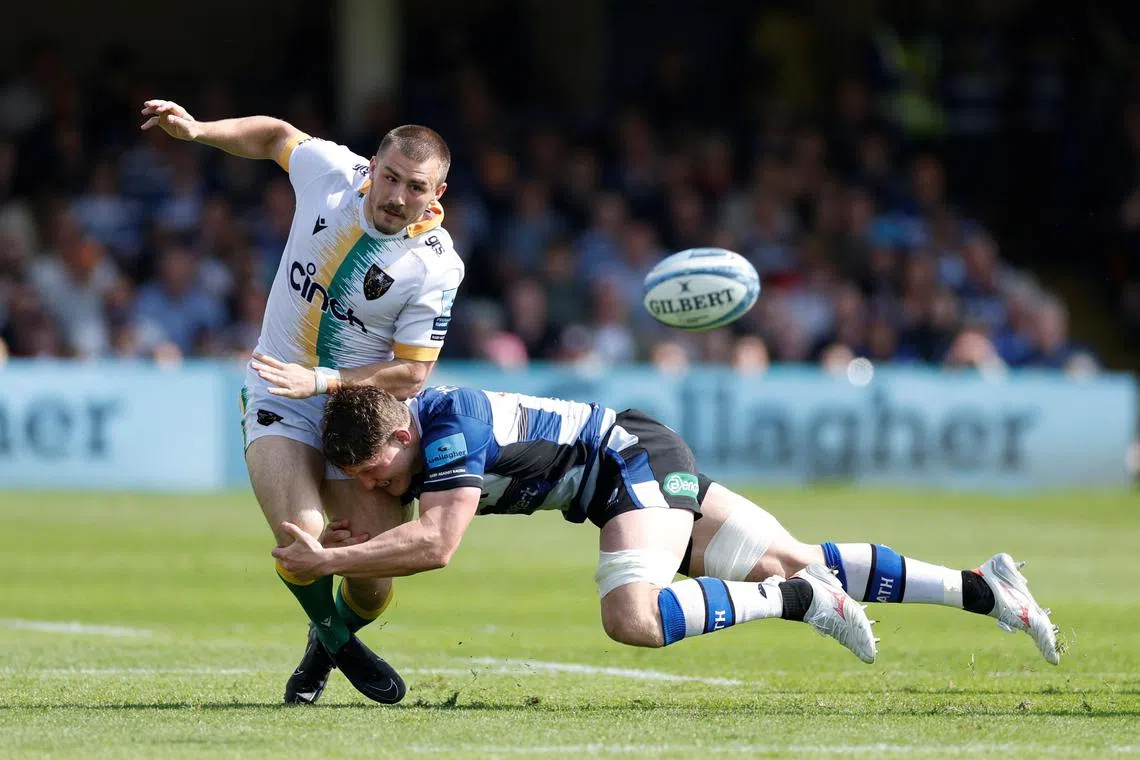 FILE PHOTO: Rugby Union - Premiership - Bath Rugby v Northampton Saints - The Recreation Ground, Bath, Britain - May 18, 2024 Northampton Saints' Ollie Sleightholme in action with Bath Rugby’s Ted Hill Action Images/John Sibley