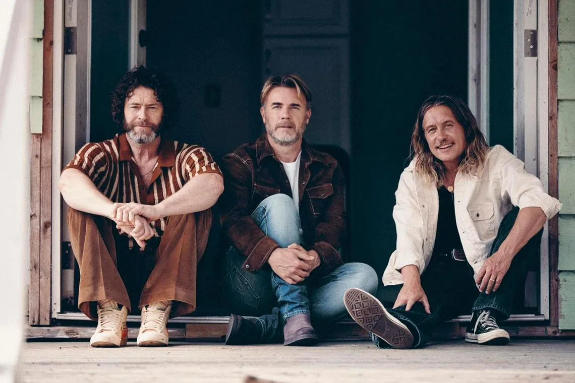 British group Take That comprises, from left to right, Howard Donald, Gary Barlow and Mark Owen.