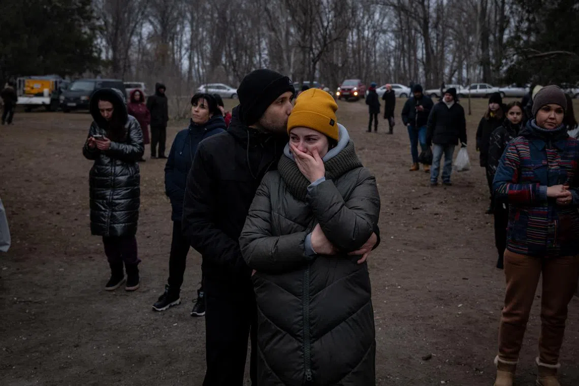 People fought back tears as they stood behind the makeshift memorial.