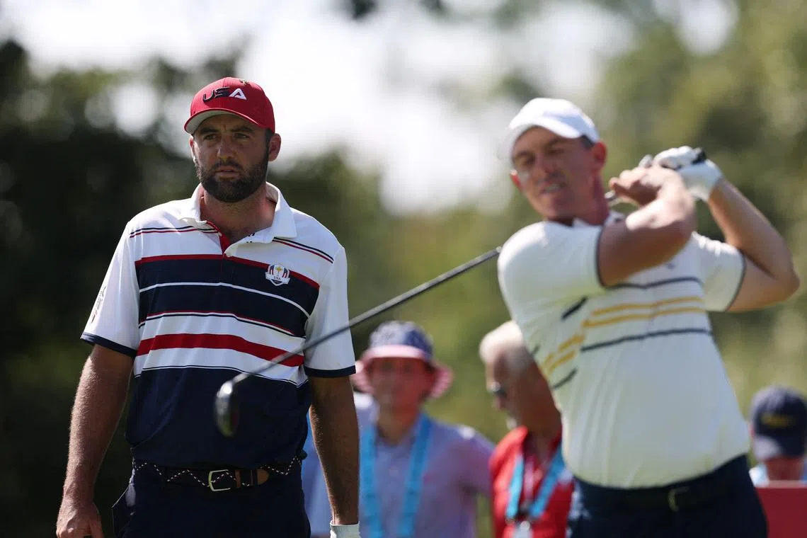 Golf - The 2025 Ryder Cup - Bethpage Black Golf Course, Farmingdale, New York, United States - September 28, 2025 Team Europe's Rory McIlroy hits his tee shot on the 2nd hole during the singles as Team USA's Scottie Scheffler looks on REUTERS/Paul Childs/File Photo