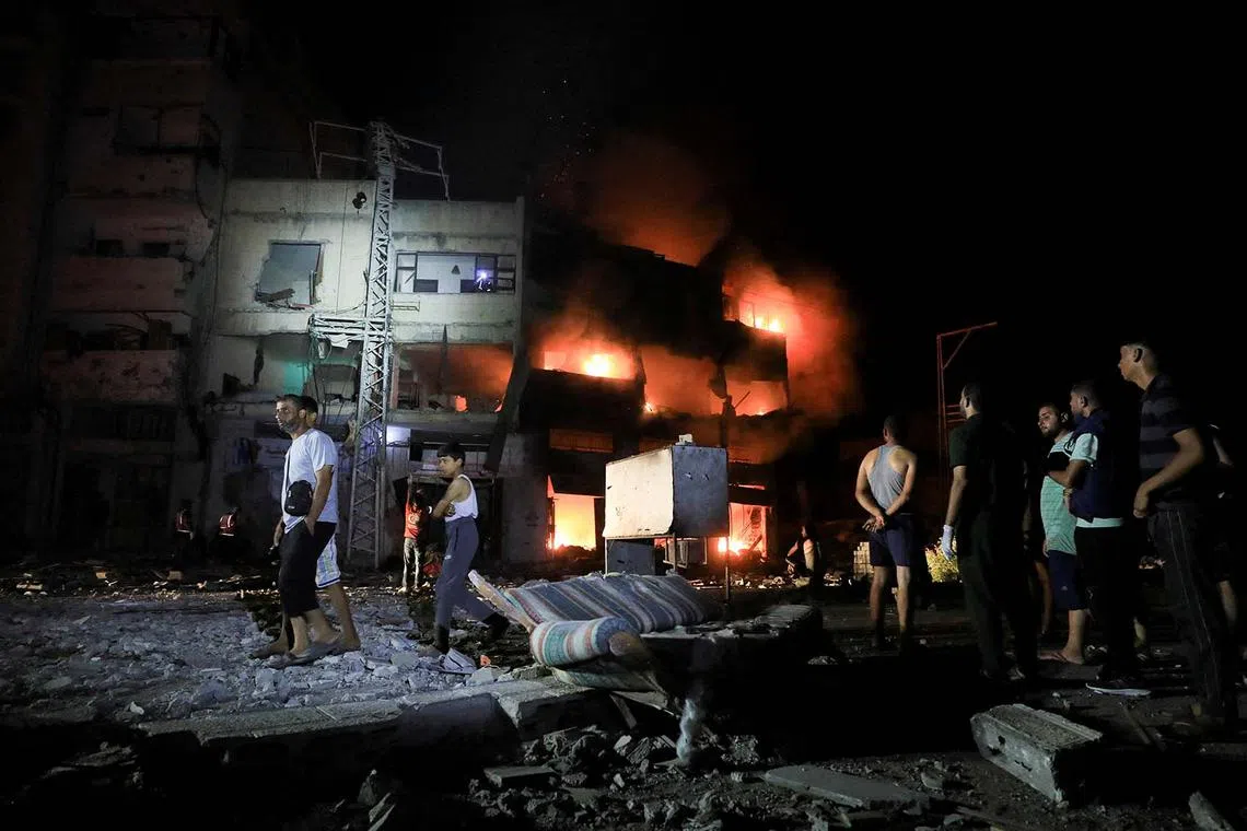 Palestinians gathering at the site of an Israeli strike at a house, amid Israel-Hamas conflict, in Gaza City, Aug 29, 2024. 