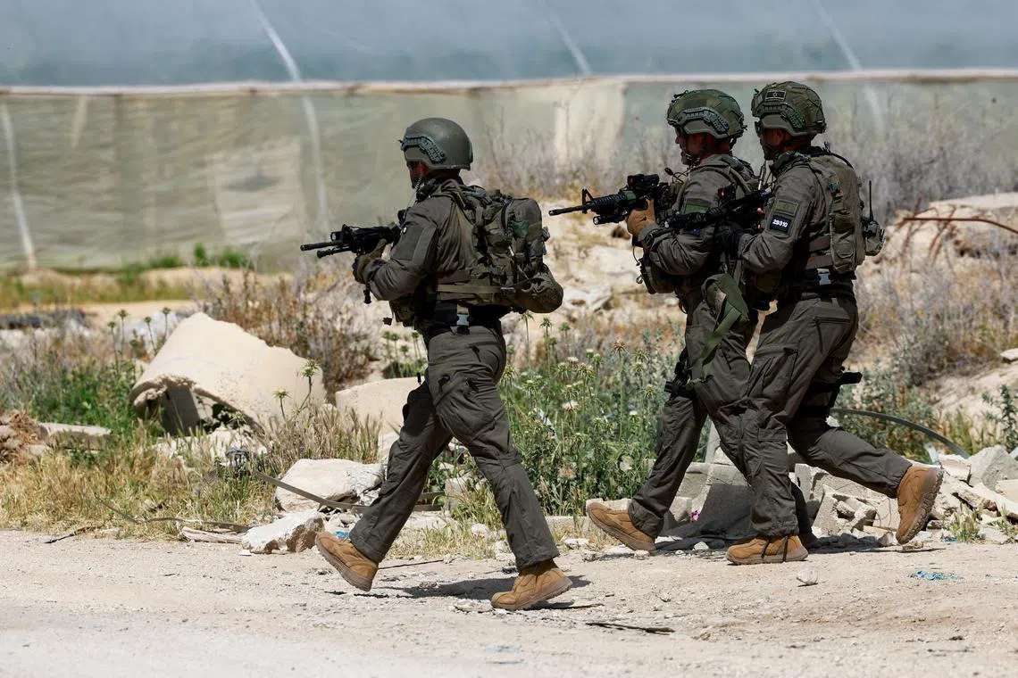 FILE PHOTO: Members of the Israeli army inspect the scene of a shooting incident, near Jericho in the Israeli-occupied West Bank, March 28, 2024. REUTERS/Ammar Awad/File photo