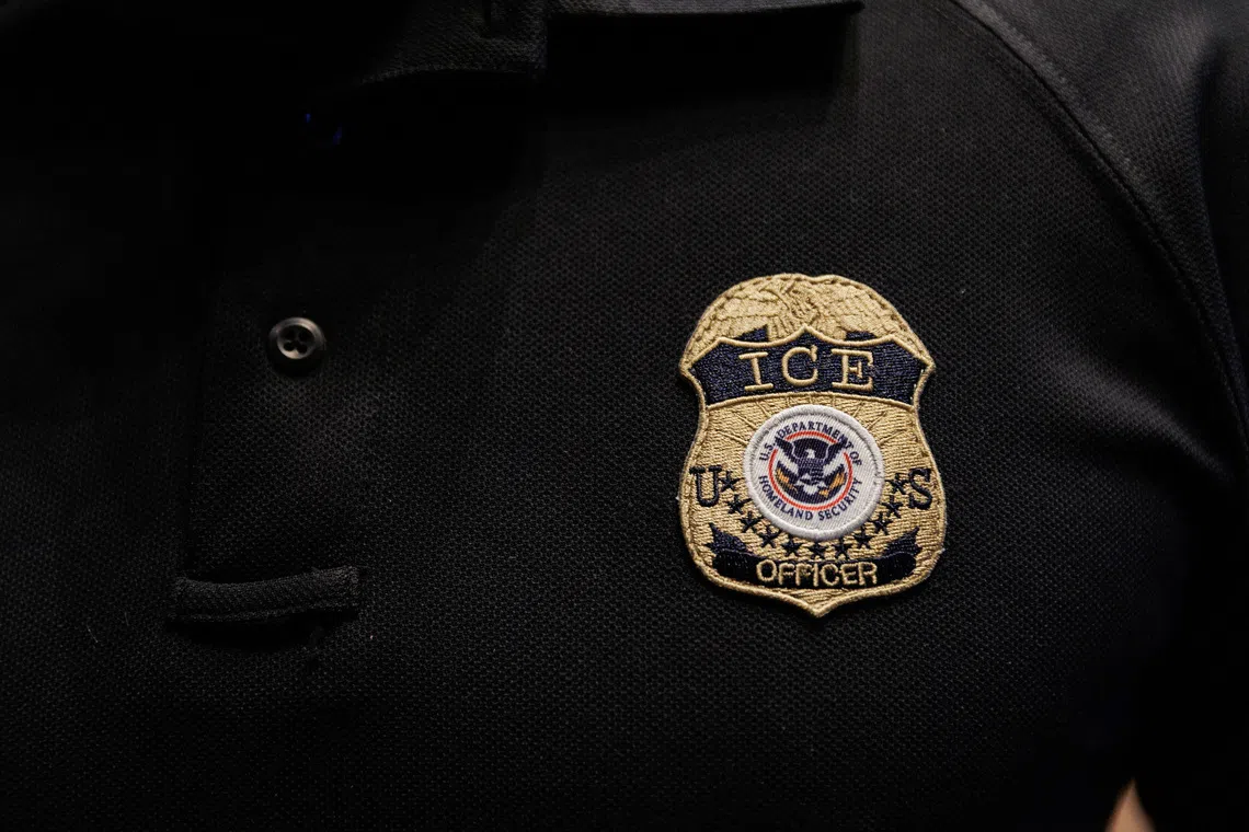 The badge of a U.S. Immigration and Customs Enforcement (ICE) is embroidered on a polo shirt of an ICE employee, at a U.S. Immigration and Customs Enforcement  two-day job fair in Texas to help fill vacancies for deportation officers and attorneys, in Arlington, Texas, U.S. August 26, 2025.  REUTERS/Shelby Tauber