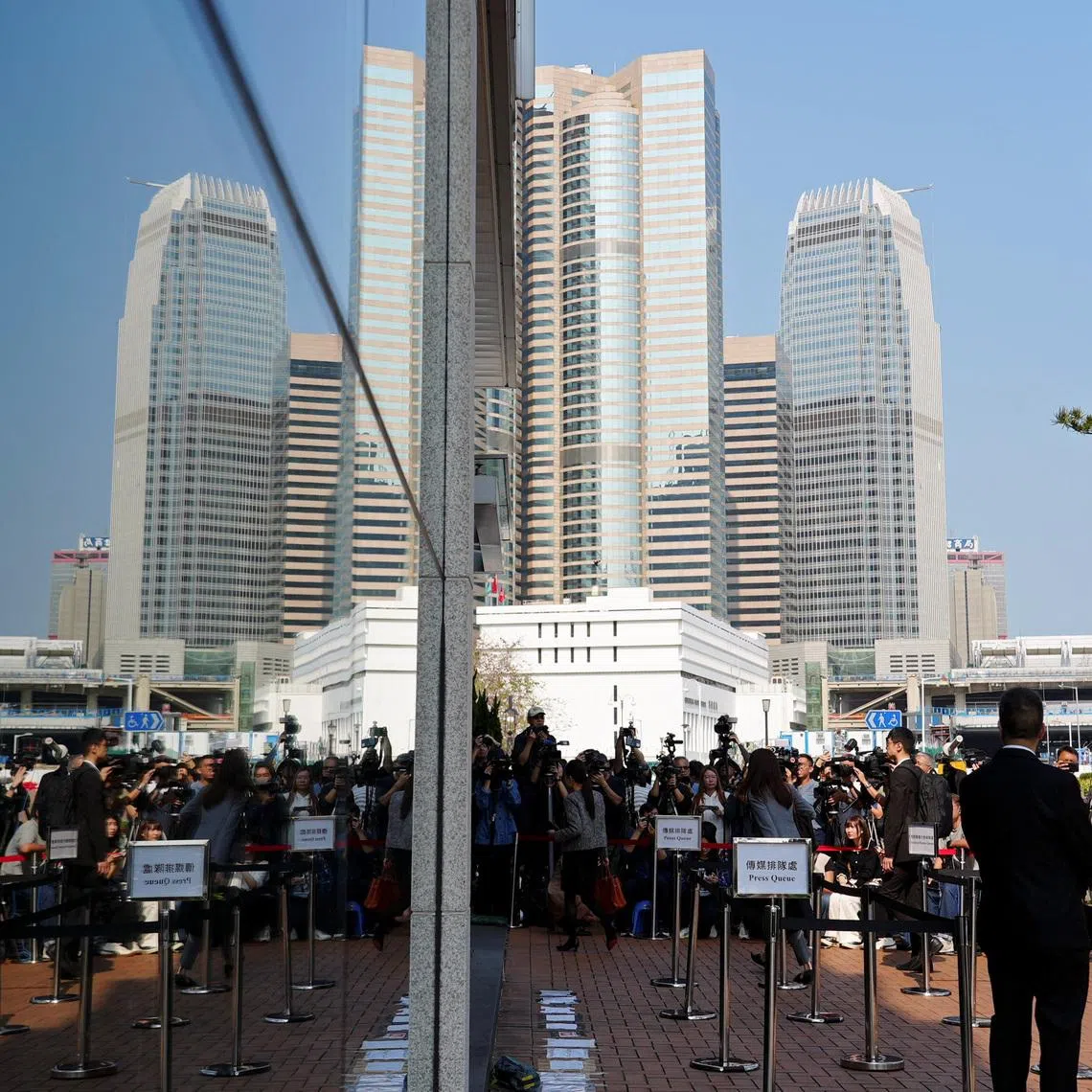 People arrive at the venue where an independent committee conducts evidential hearings for the deadly fire at Wang Fuk Court in Tai Po last November, in Hong Kong, China March 19, 2026. REUTERS/Joyce Zhou