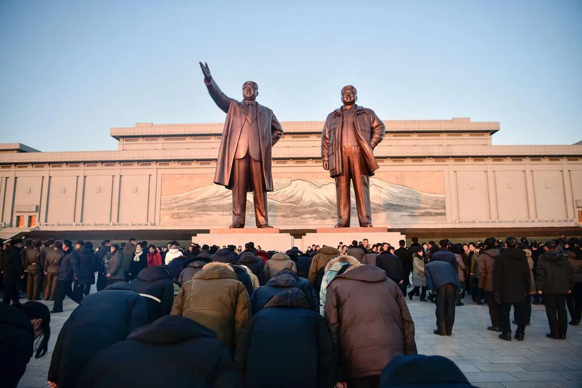 People visit Mansu Hill to pay their respects in front of statues of late North Korean leaders Kim Il Sung and Kim Jong Il, to mark the 13th anniversary of the death of Kim Jong Il, the father of current leader Kim Jong Un.