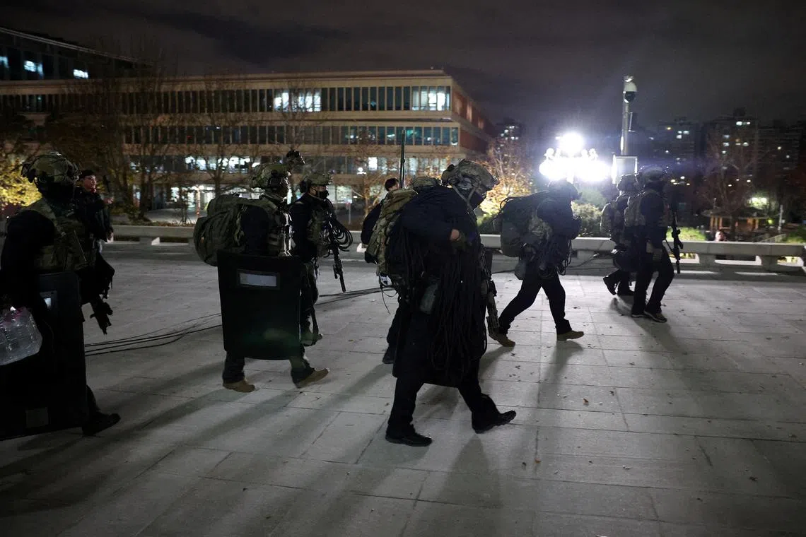Military forces walk outside the National Assembly, after President Yoon Suk Yeol declared martial law on Dec 4.