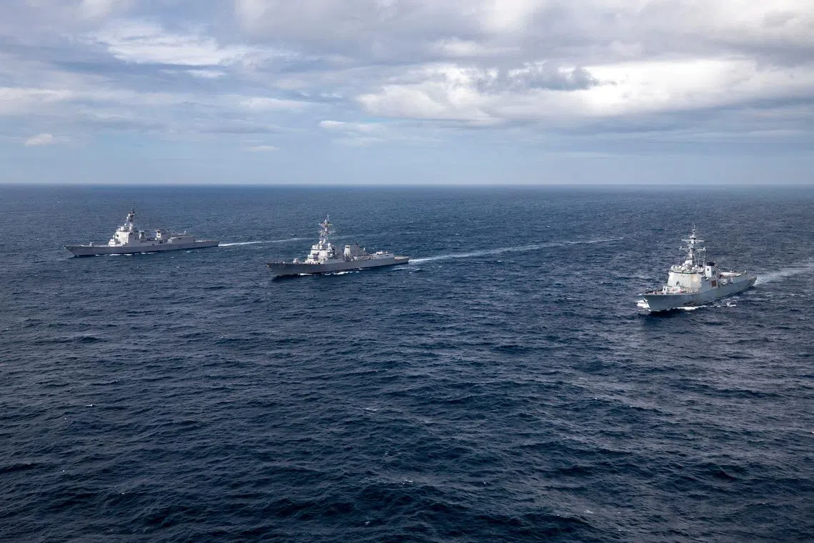 FILE PHOTO: Se Jong Daewang class destroyer ROKS Yul Gog Yi I (DDG 992) of the Republic of Korea Navy and Atago class destroyer JS Maya (DDG 179) of the Japanese Maritime Self-Defense Force sail alongside the U.S. Navy's Arleigh Burke-class guided-missile destroyer USS John Finn (DDG 113) while conducting a trilateral ballistic missile defense exercise in the Sea of Japan July 16, 2023/File Photo