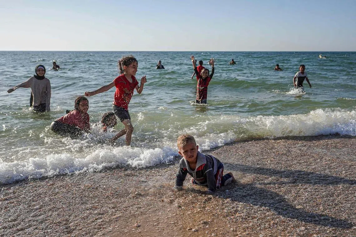 Palestinian children playing on a beach in Deir el-Balah in the central Gaza Strip on April 17, 2024.