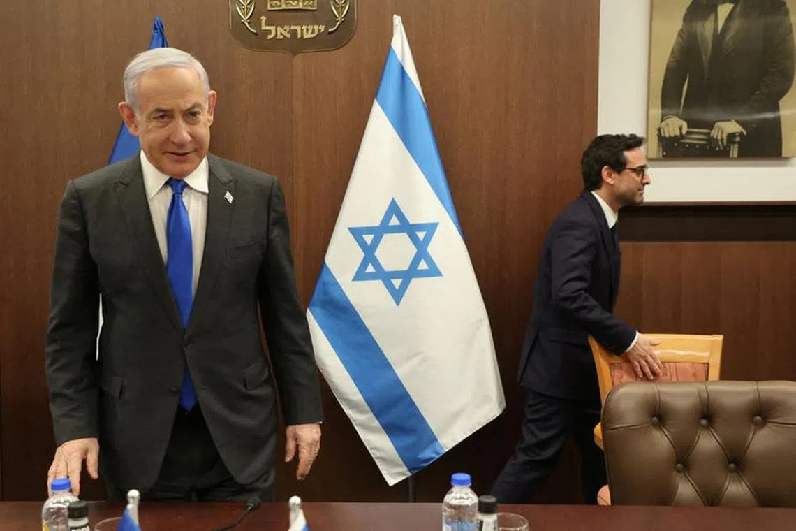 FILE PHOTO: Israeli Prime Minister Benjamin Netanyahu takes a seat as he meets with French Foreign Minister Stephane Sejourne in Jerusalem on February 5, 2024. GIL COHEN-MAGEN/Pool via REUTERS/File Photo