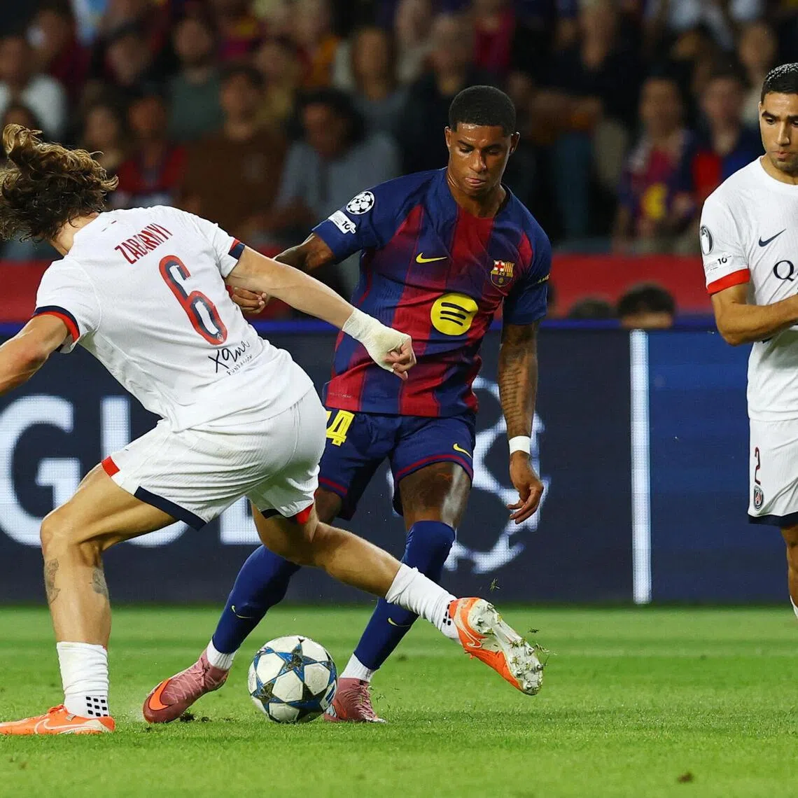 Barcelona's Marcus Rashford taking on Paris Saint-Germain players in their Champions League clash.