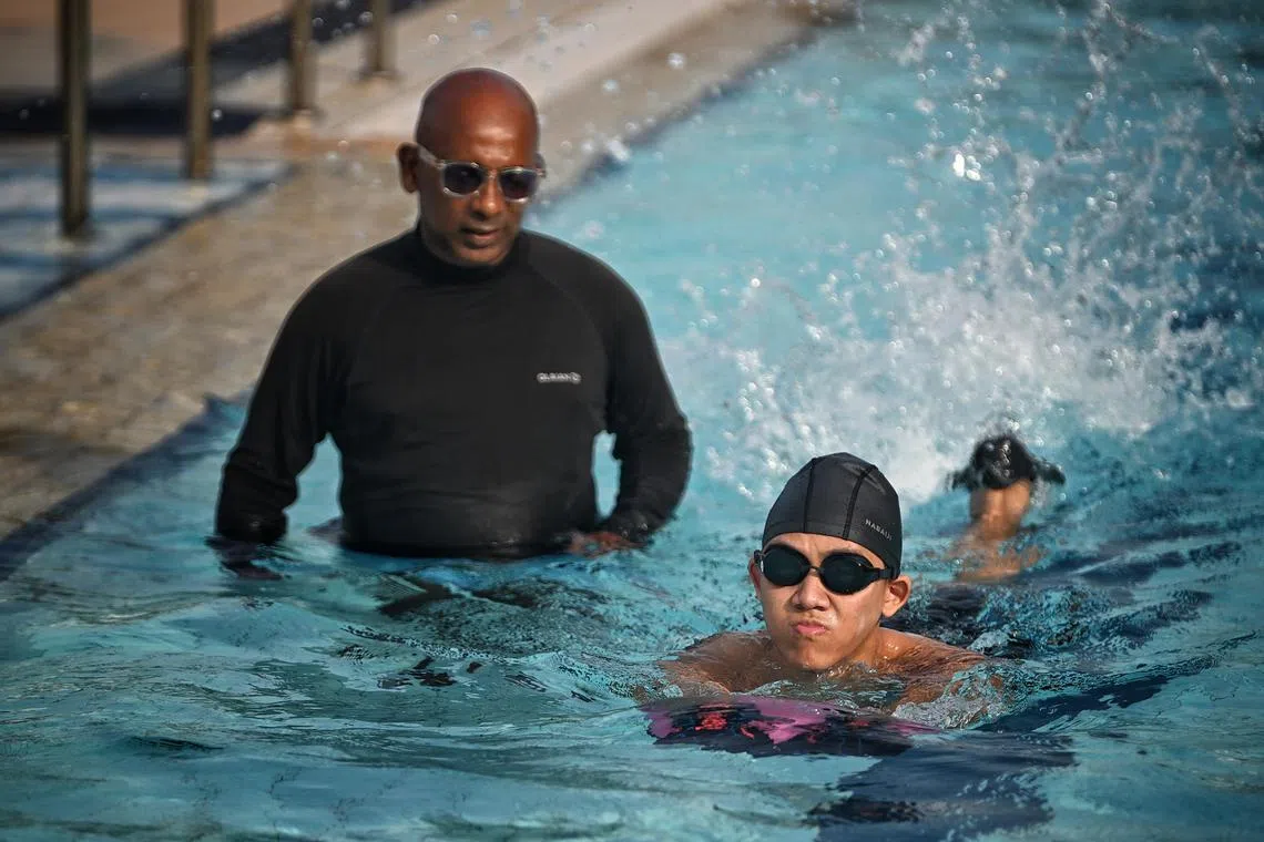 Mr Teo Yong Le and his coach Silas Parasurmam (left) at Jurong West Swimming Complex on Jan 14, 2023.