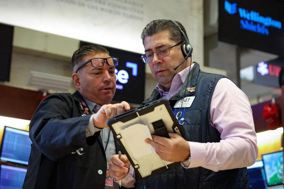 Traders working on the floor of the New York Stock Exchange, in New York City, on Sept 11.