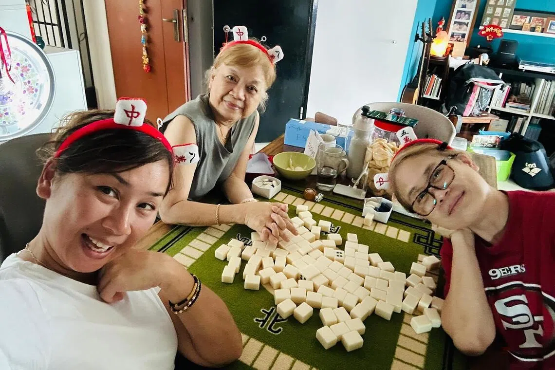 Singaporean actress Vernetta Lopez (right) plays mahjong with her mother, Doreen (centre) and older sister  Loretta (left).
