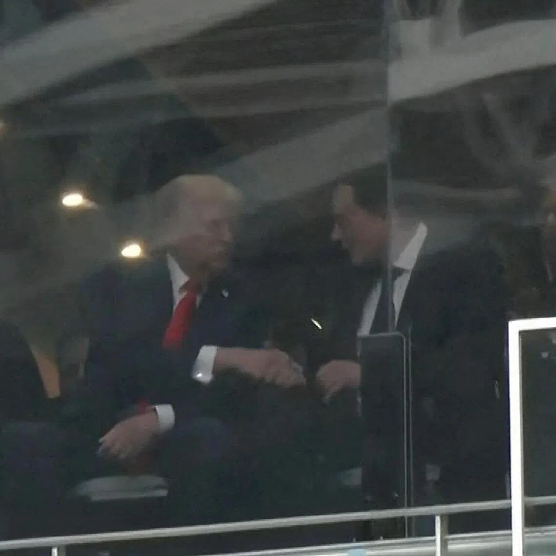A still image from video shows US President Donald Trump and Tesla CEO Elon Musk shaking hands in a skybox at State Farm Stadium during the memorial service for slain conservative commentator Charlie Kirk, in Glendale, Arizona on Sept 21. 