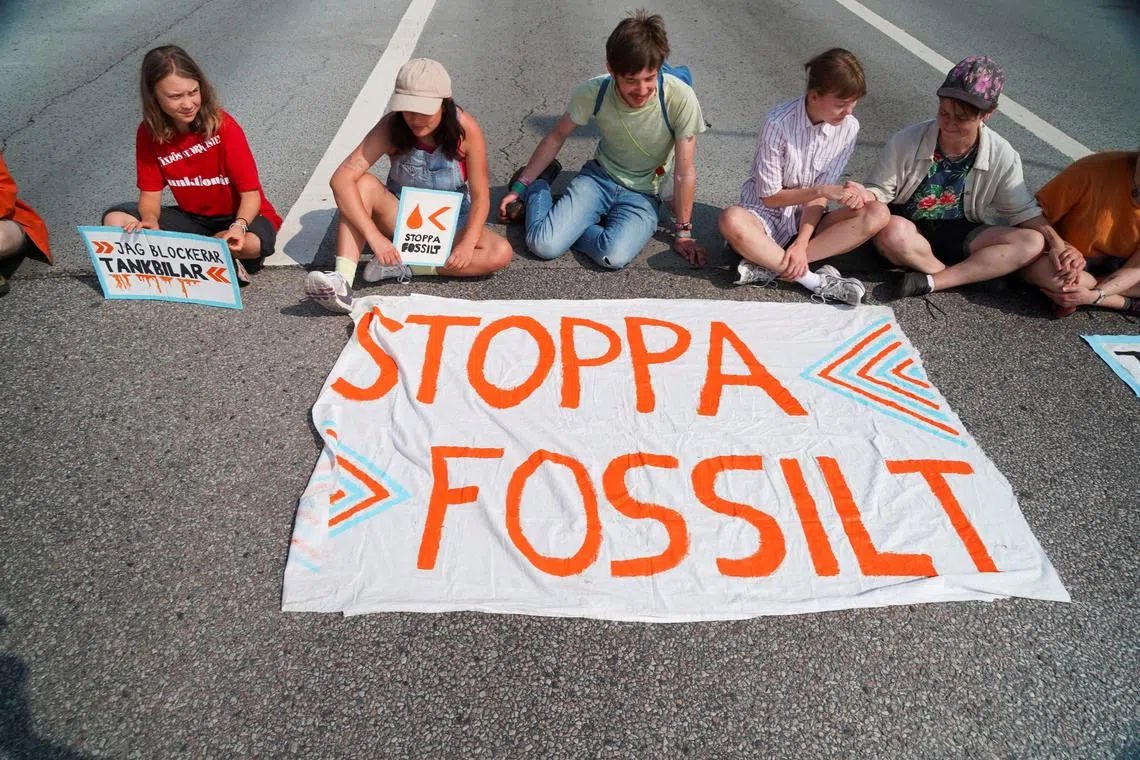 Members of the group Ta Tillbaka Framtiden and Greta Thunberg block a road at the entrance of Oljehamnen as they hold a protest, in Malmo, Sweden, June 20, 2023. REUTERS/Tom Little/File Photo