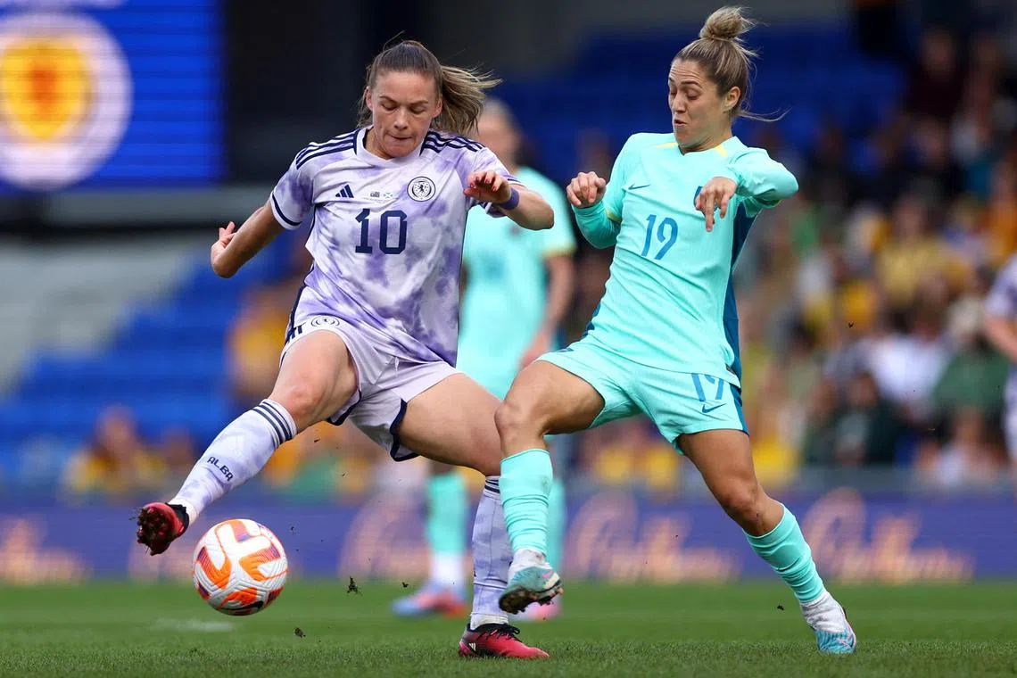 Scotland's Kirsty Hanson (left) in action with Australia's Katrina Gorry during a friendly match.