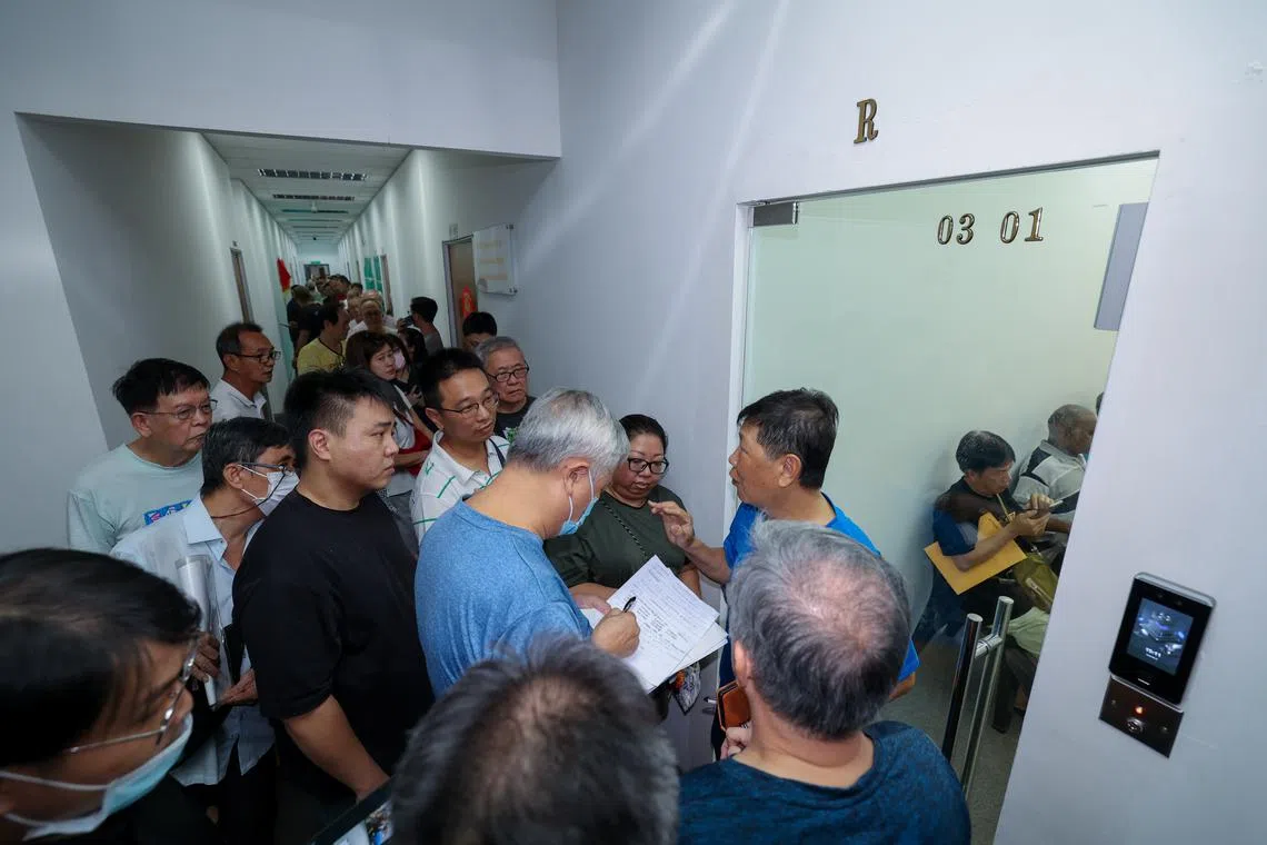 CMG20240819-NgohSB01/吴先邦/何家炜/Entry to malaysia : VEP[level 3,186 Woodlands Industrial Park E5]people in queue trying to ask for help regarding their VEP registration issues. Man in blue was seen trying to explain what the purpose of the office is to the people queuing