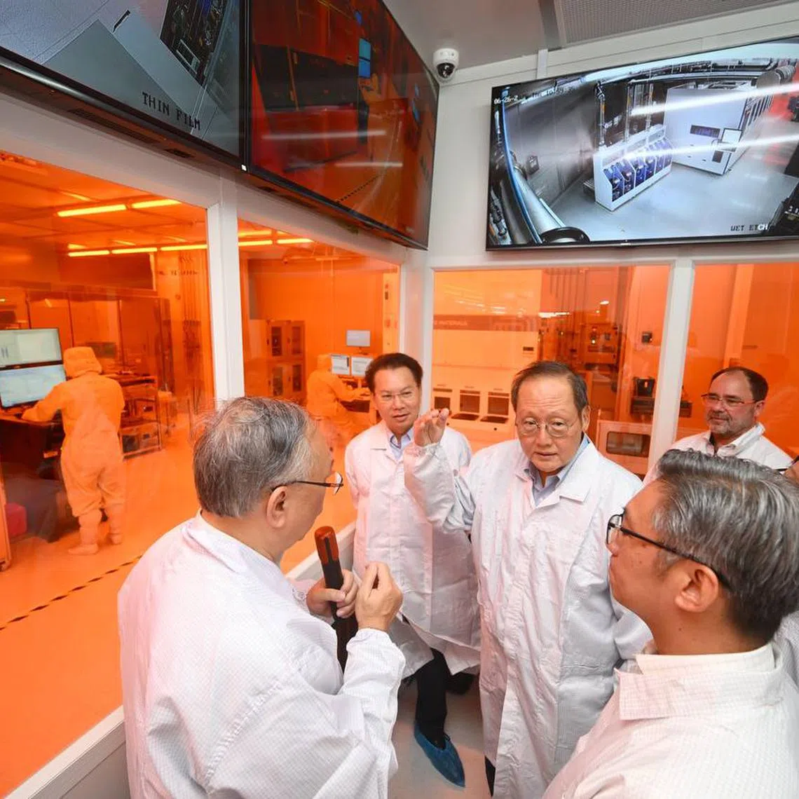 Minister-in-charge of Energy and Science & Technology Tan See Leng (centre) tours the cleanroom at the National Semiconductor Translation and Innovation Centre for Gallium Nitride during its launch on June 26.