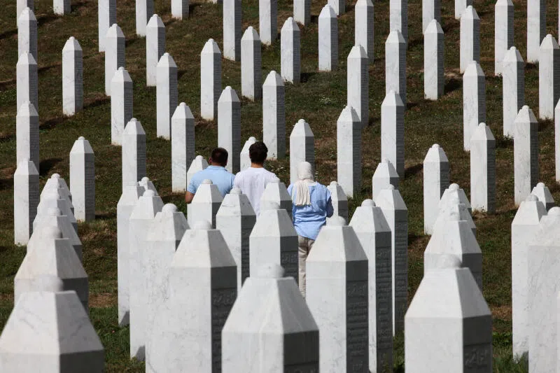 People visiting the cemetery in Potocari, where the victims of the 1995 Srebrenica massacre are buried.