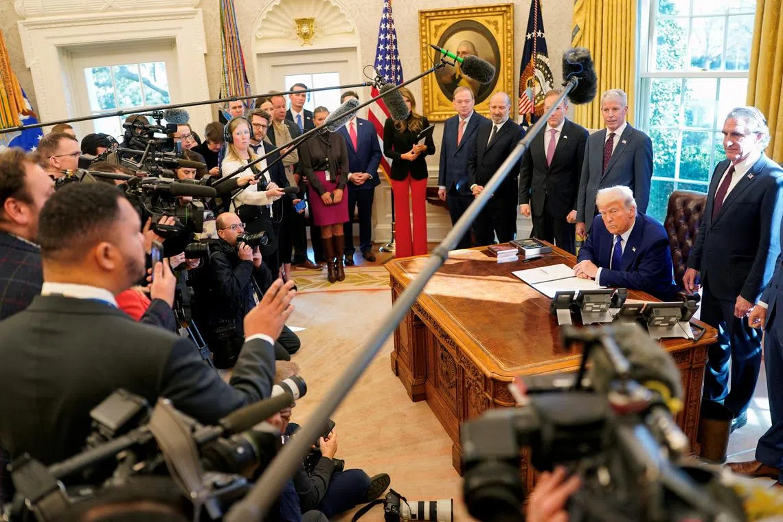 FILE PHOTO: U.S. President Donald Trump looks on, after signing an executive order, in the Oval Office, at the White House in Washington, D.C., U.S. February 14, 2025.  REUTERS/Nathan Howard/File Photo