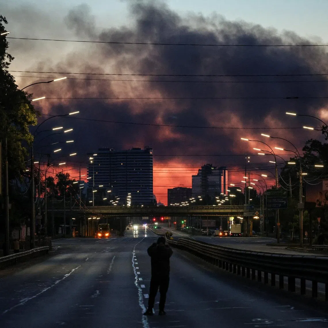 Smoke rises in the background after an overnight Russian missile and drone strike in Kyiv on June 2. Russia struck major Ukrainian centres including Kyiv, Dnipro and Kharkiv early that day.