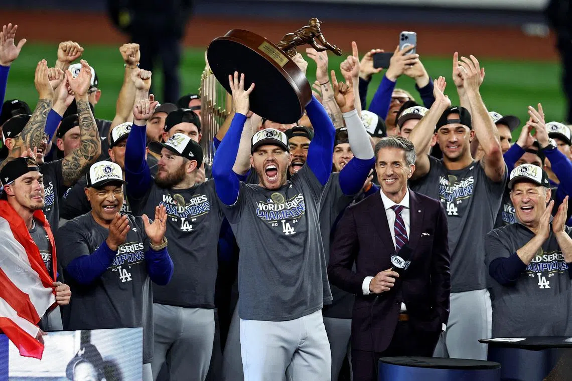 Los Angeles Dodgers first baseman Freddie Freeman celebrates with the Willie Mays World Series Most Valuable Player award.
