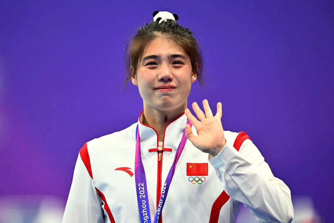 Asian Games - Hangzhou 2022 - Swimming - Sports Centre Aquatic Sports Arena Hangzhou, China - September 29, 2023  Gold medallist China's Zhang Yufei reacts on the podium during the medal ceremony for the Women's 50m Butterfly REUTERS/Andy Chua/ File Photo