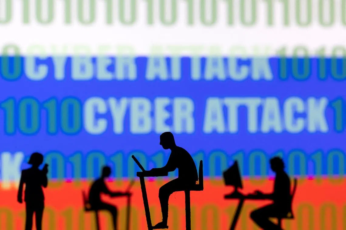 FILE PHOTO: Figurines with computers and smartphones are seen in front of the words \"Cyber Attack\", binary codes and the Russian flag, in this illustration taken February 15, 2022. REUTERS/Dado Ruvic/Illustration/File Photo