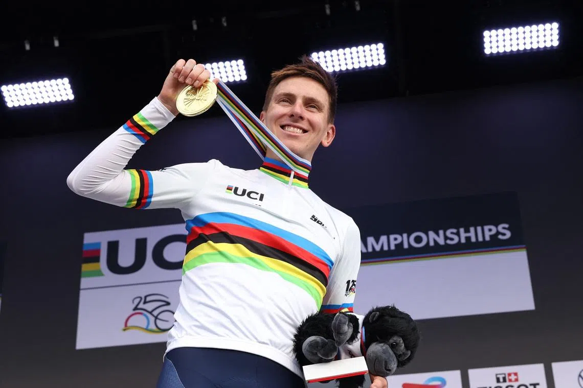 Cycling - Road World Championships 2025 - Kigali, Rwanda - September 28, 2025 Slovenia's Tadej Pogacar celebrates on the podium after winning the Men's Elite Road Race REUTERS/Jean Bizimana