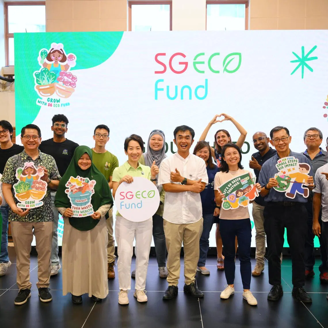 Minister for Sustainability and the Environment Grace Fu (front row, fourth from left) and Senior Parliamentary Secretary for the Ministry of Sustainability and the Environment Goh Hanyan (front row, third from right) with recipients of the SG Eco Fund at Vidacity on June 21, 2025.